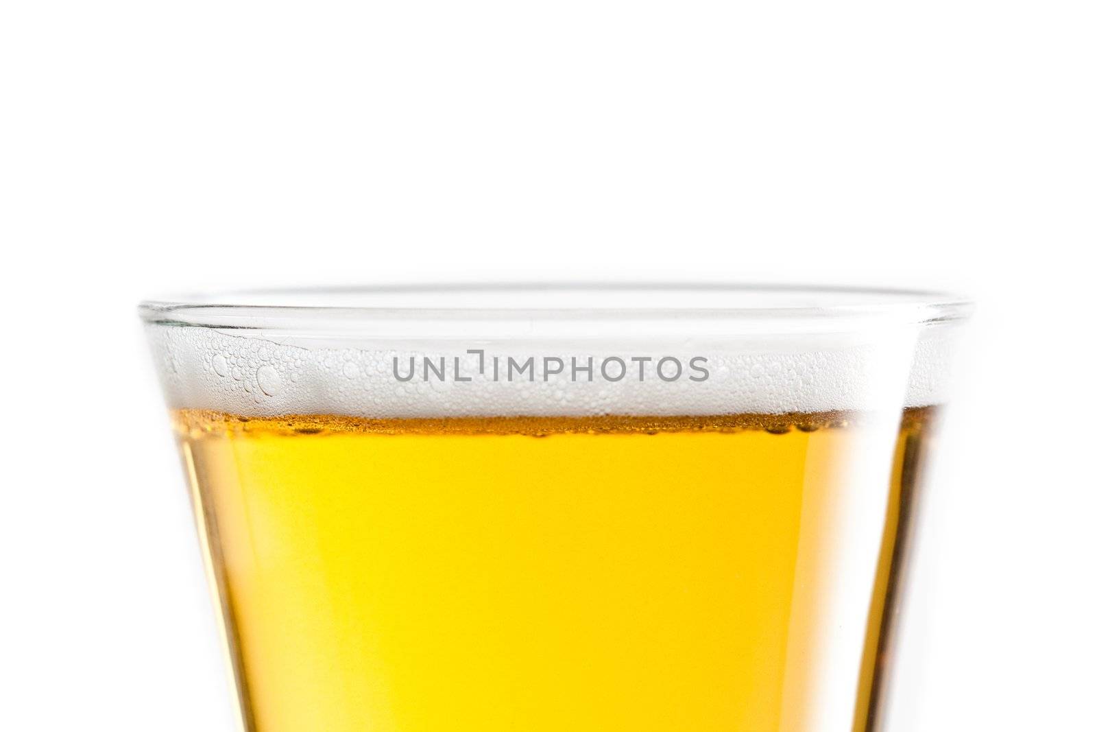 Top of a full glass of beer against a white background