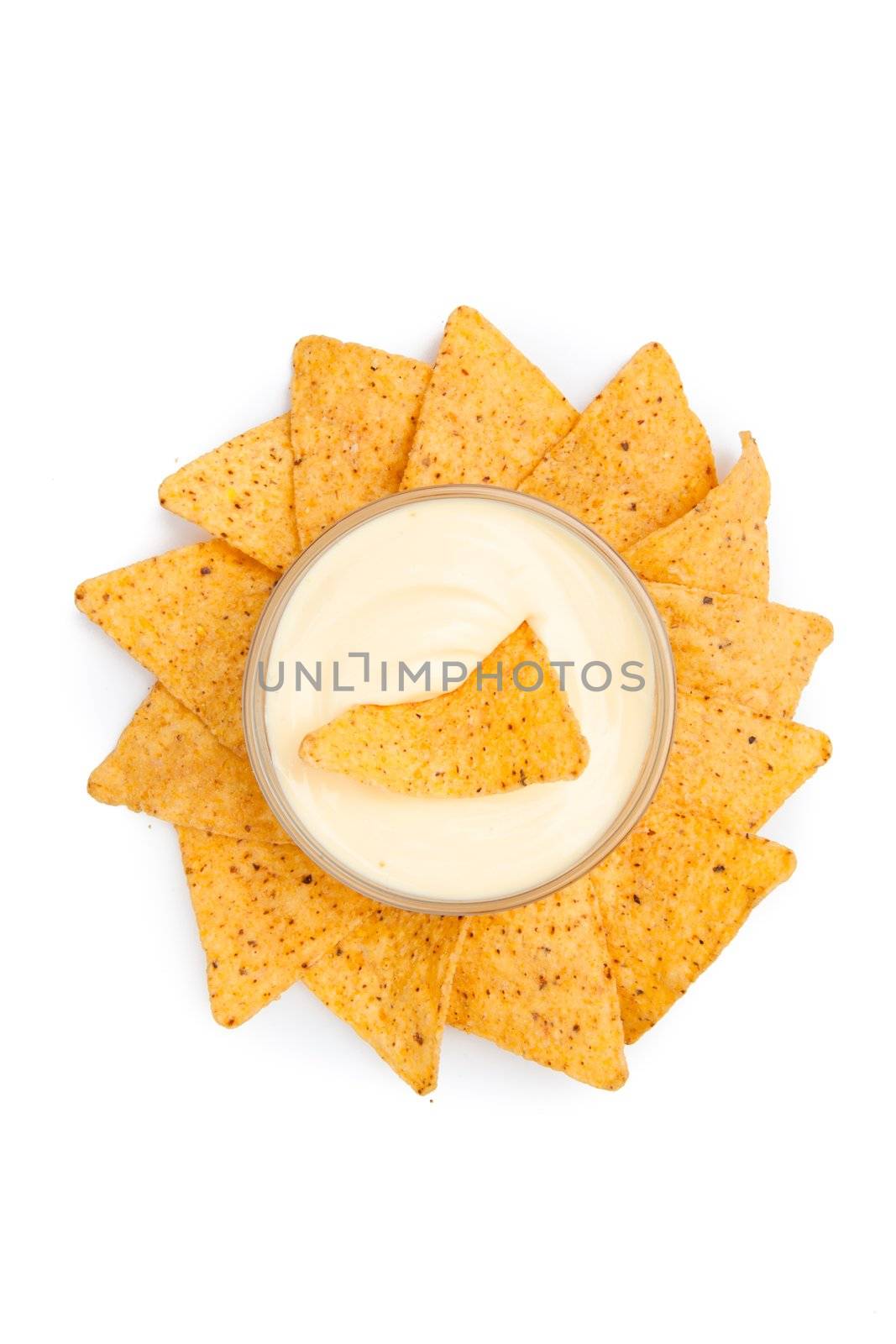 Bowl of white dip surrounded by nachos by Wavebreakmedia