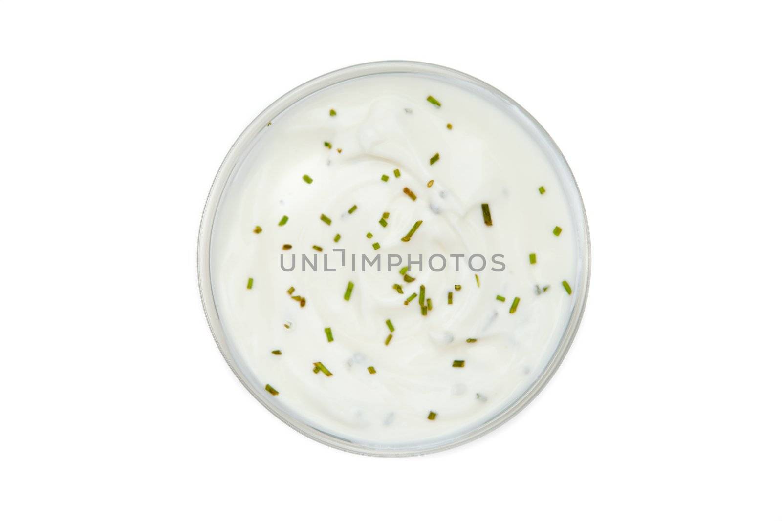 Bowl of dip with herbs against a white background