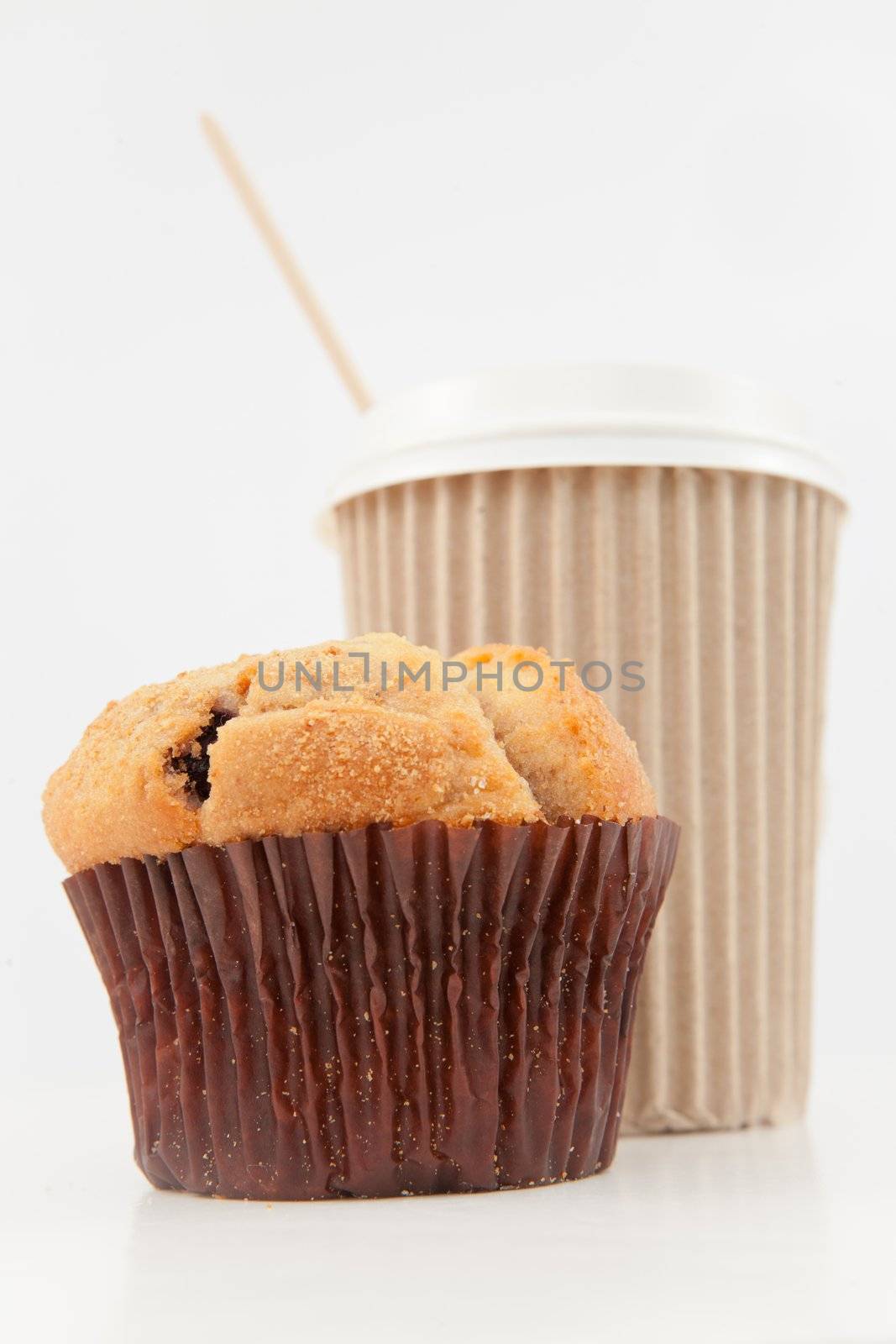 Muffin and a cup of coffee placed together by Wavebreakmedia