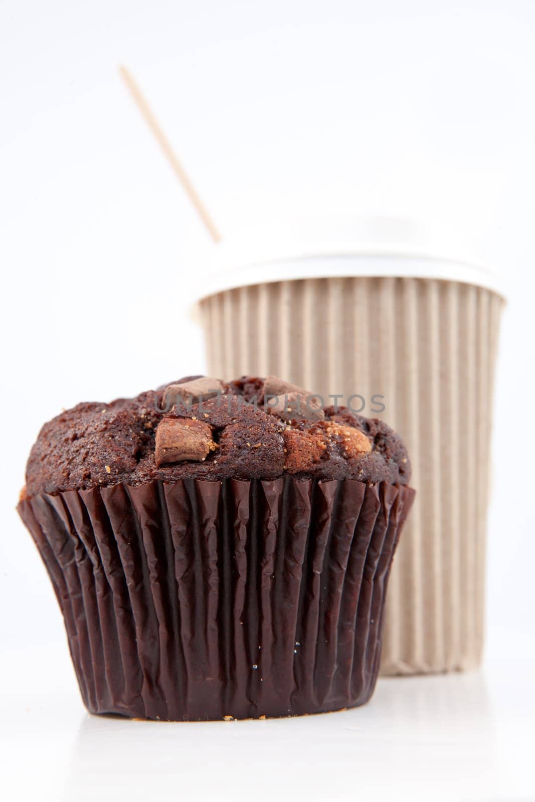 Chocolate muffin and a cup of coffee placed together by Wavebreakmedia