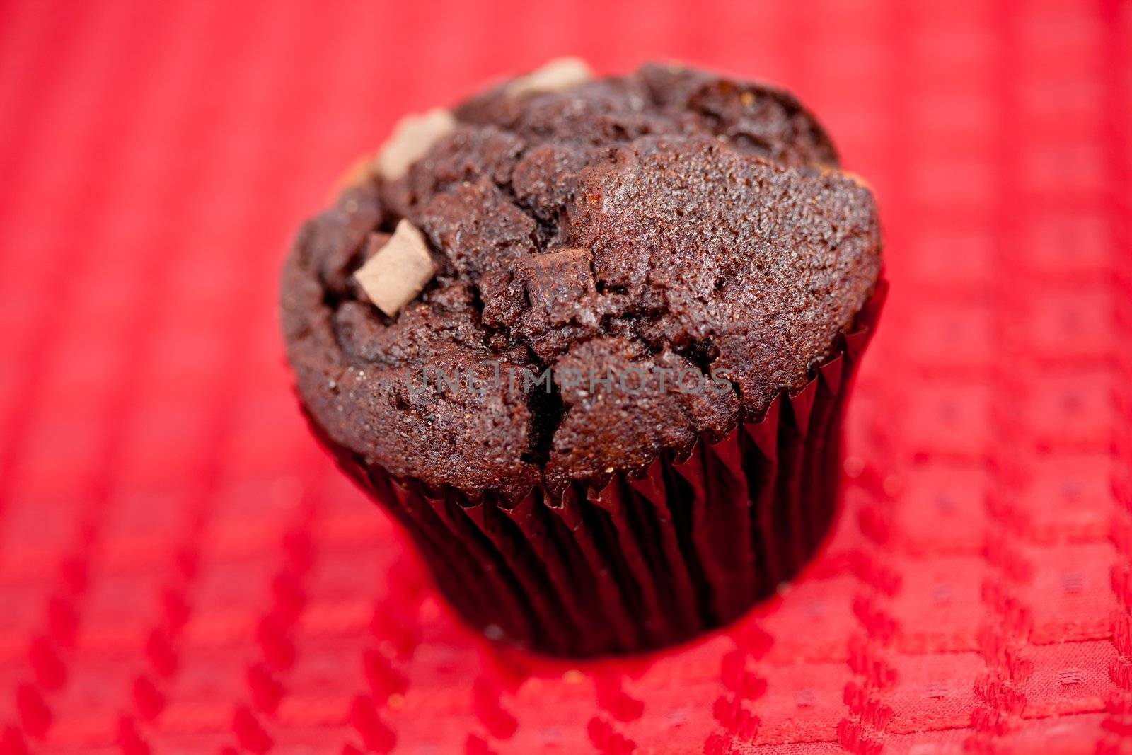 Chocolate muffin on a red tablecloth