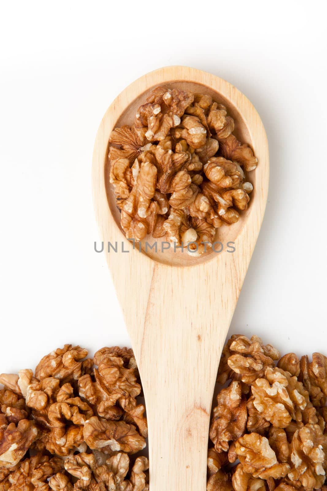 Wooden spoon with nuts by Wavebreakmedia