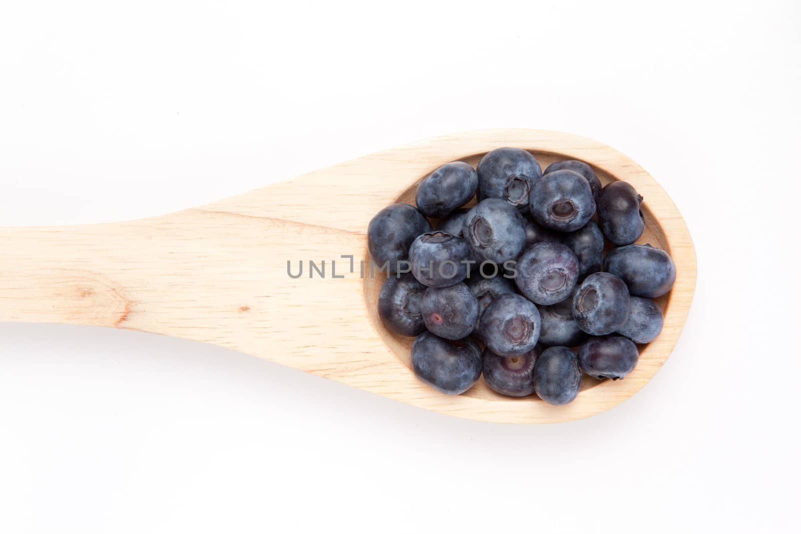 Wooden spoon with blueberry against a white background
