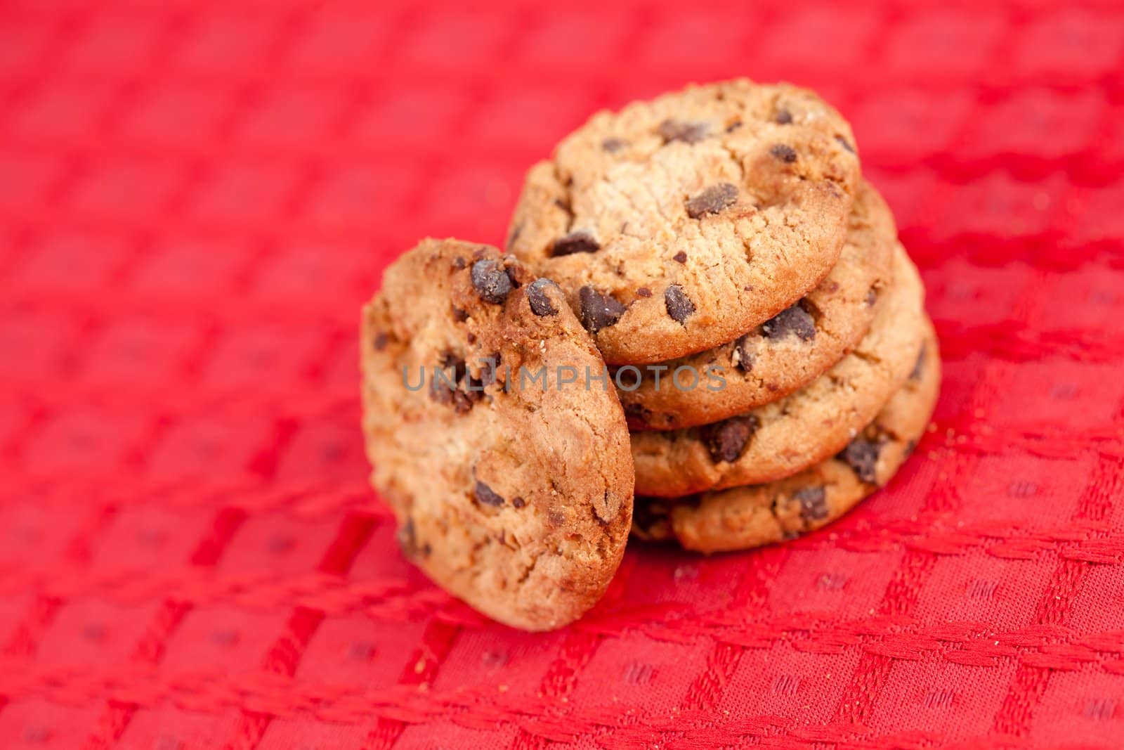 Five cookies laid out together on a red tablecloth