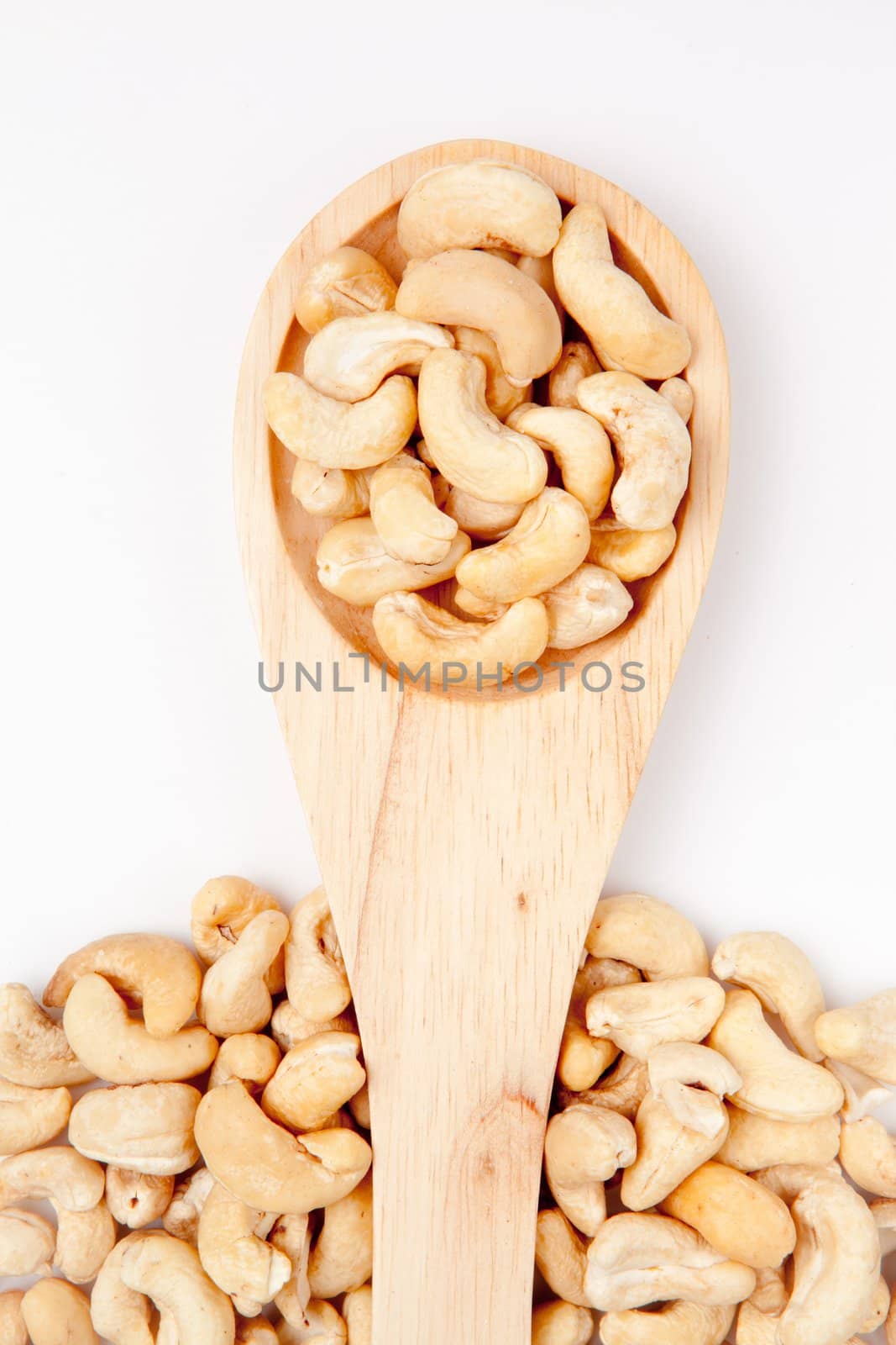 Wooden spoon with cashew nuts by Wavebreakmedia