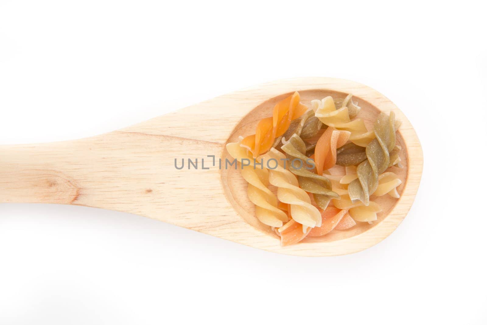 Wooden spoon with pasta  against a white background