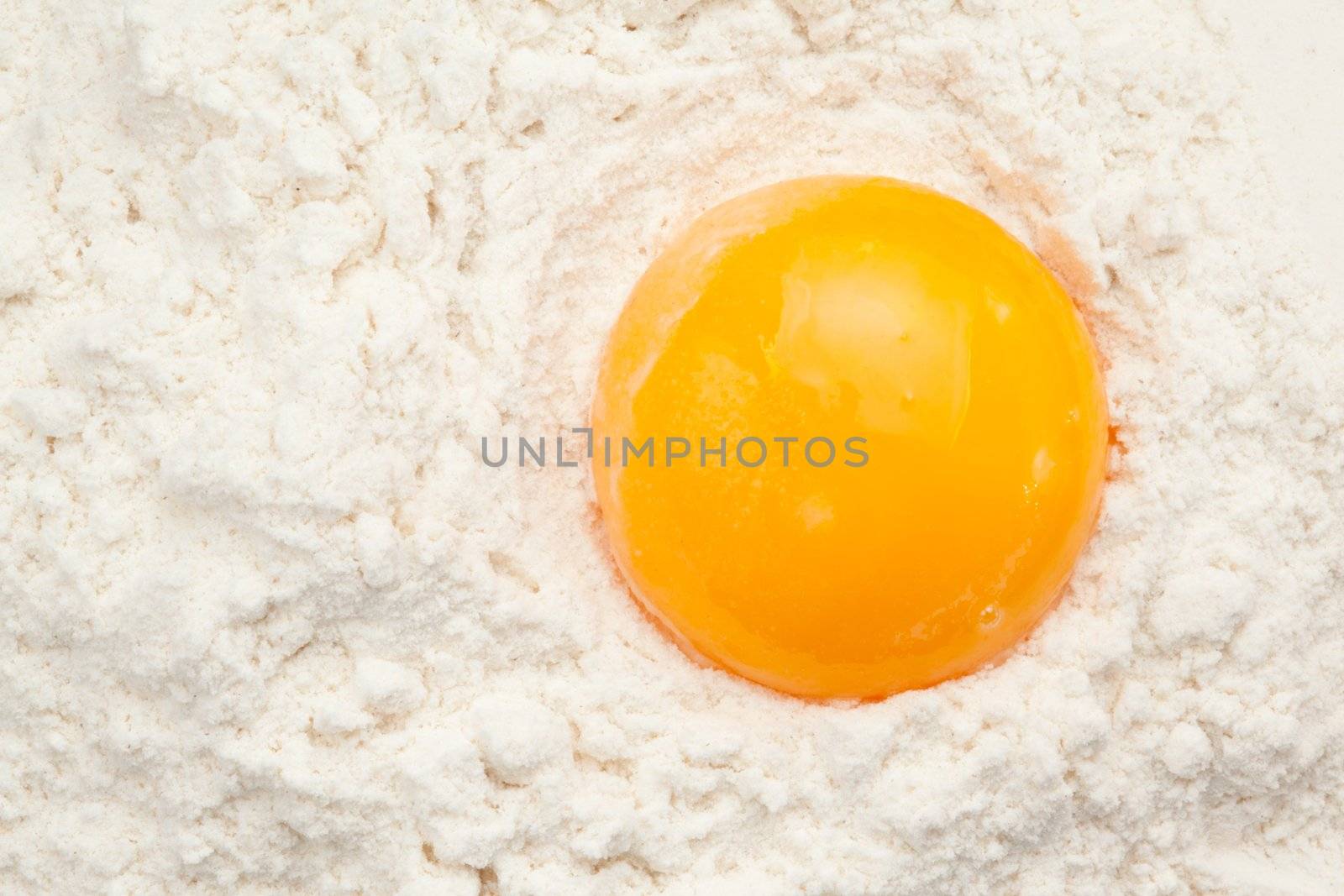 Egg yolk on the flour in a high angle view
