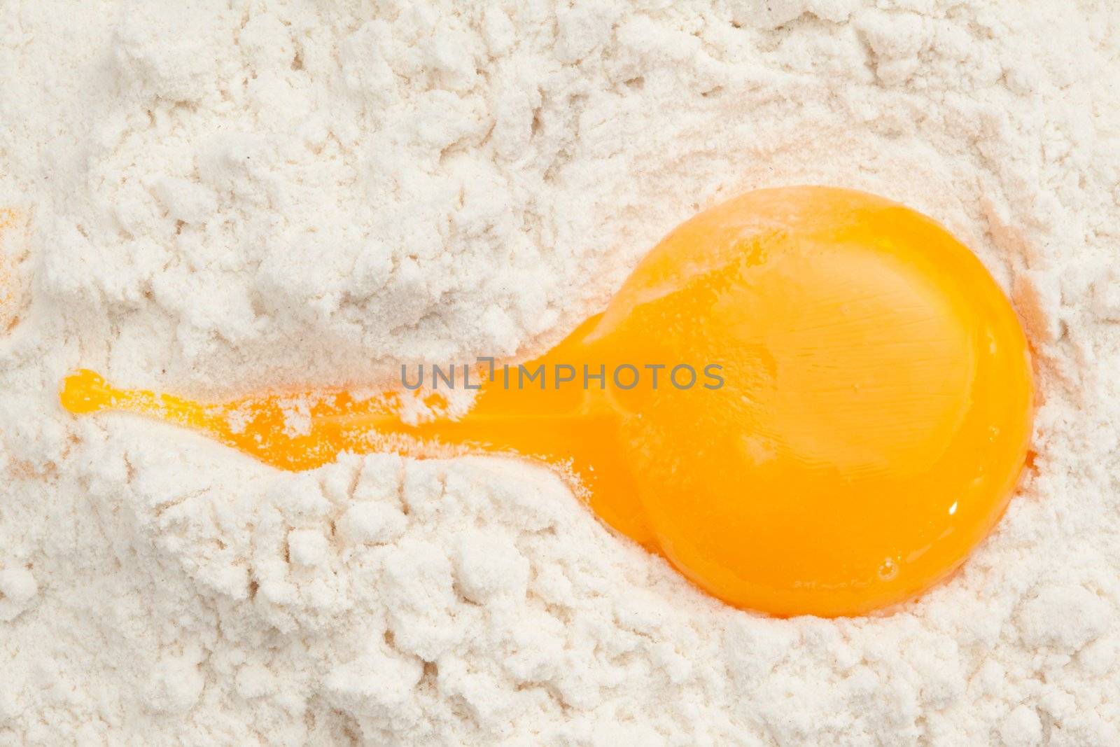 Egg yolk on the flour by Wavebreakmedia
