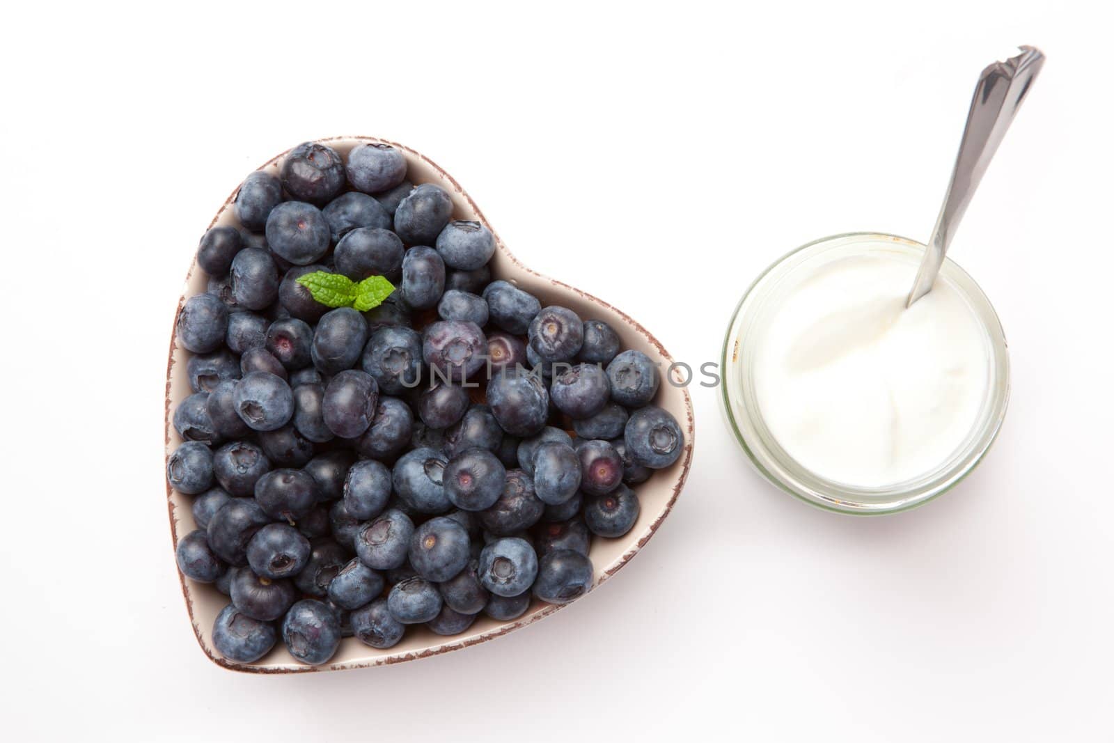 White yogurt and blueberries in a bowl  by Wavebreakmedia