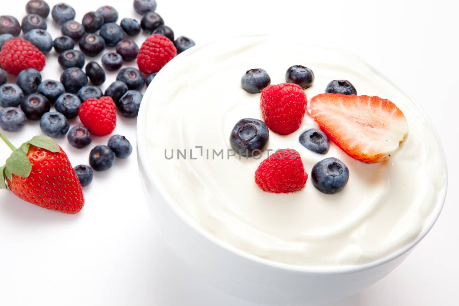 Bowl of cream with berries by Wavebreakmedia