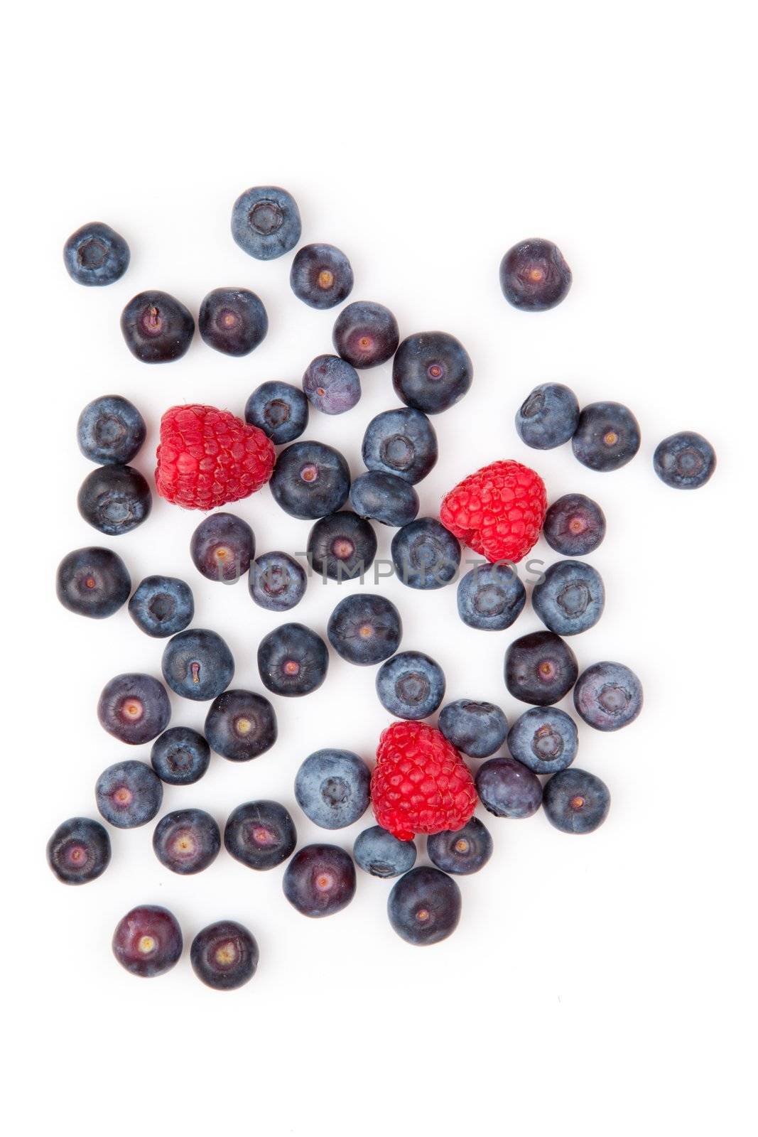 Raspberries and blueberries against a white background