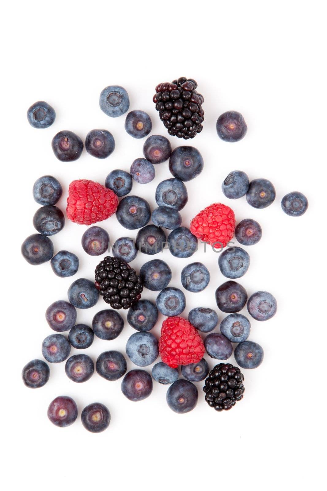 Raspberries and blueberries and blackberries  against a white background