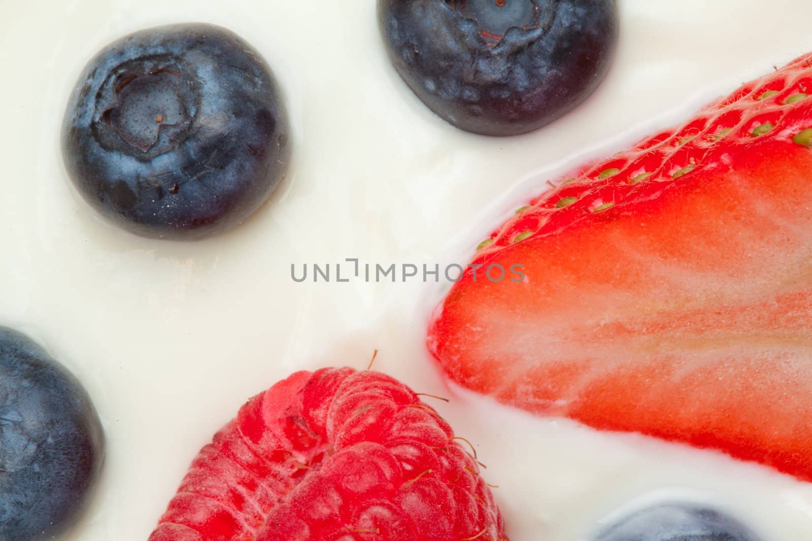 Slice berries on the cream in a high angle shot