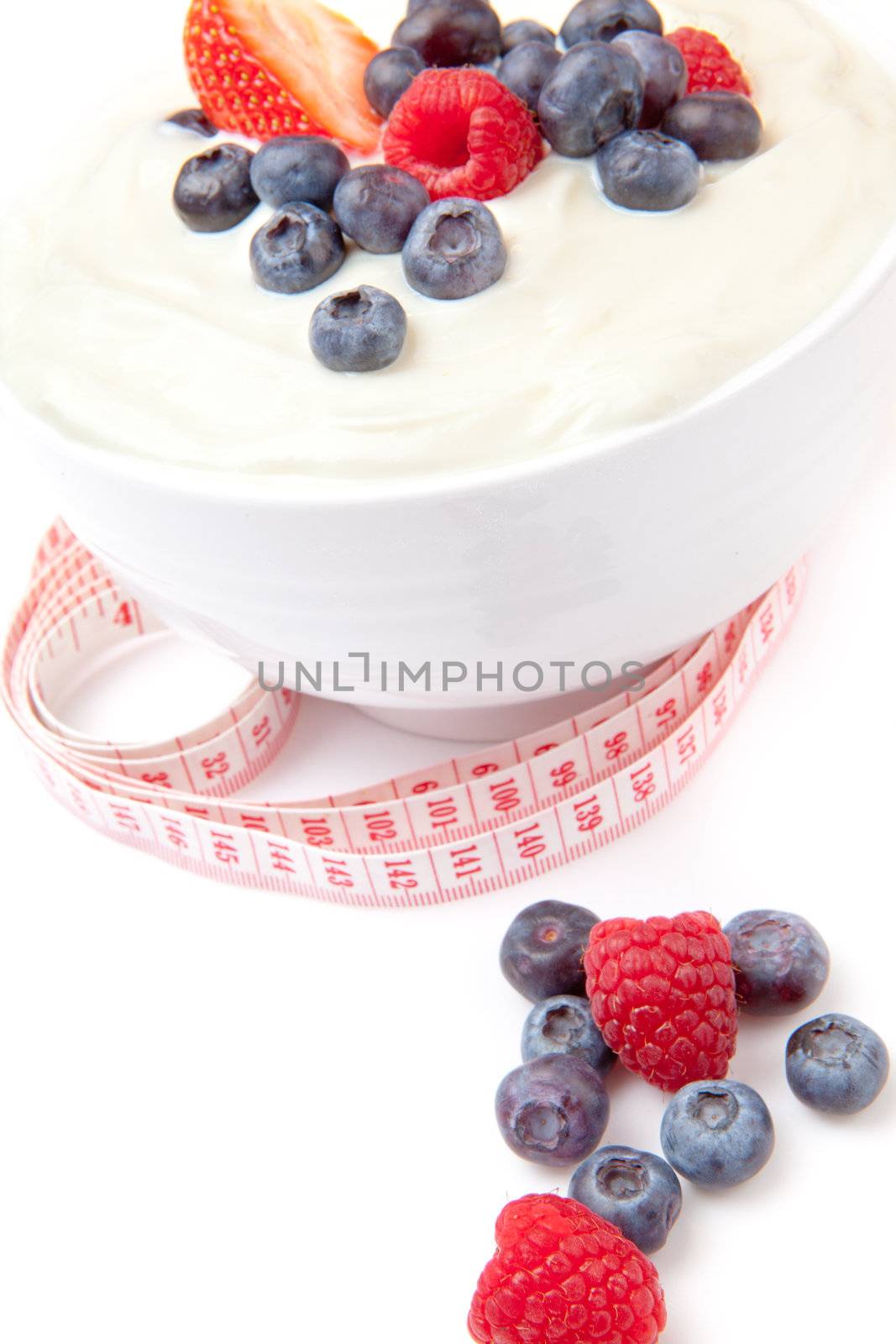 Different berries cream with a tape measure by Wavebreakmedia
