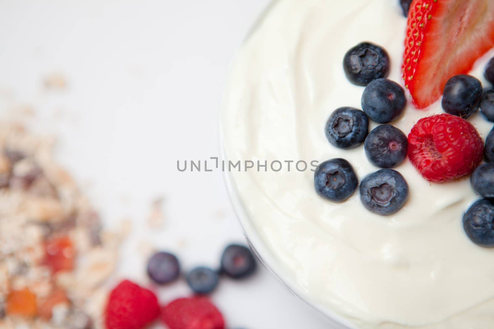 Cereals and berries cream against a white background