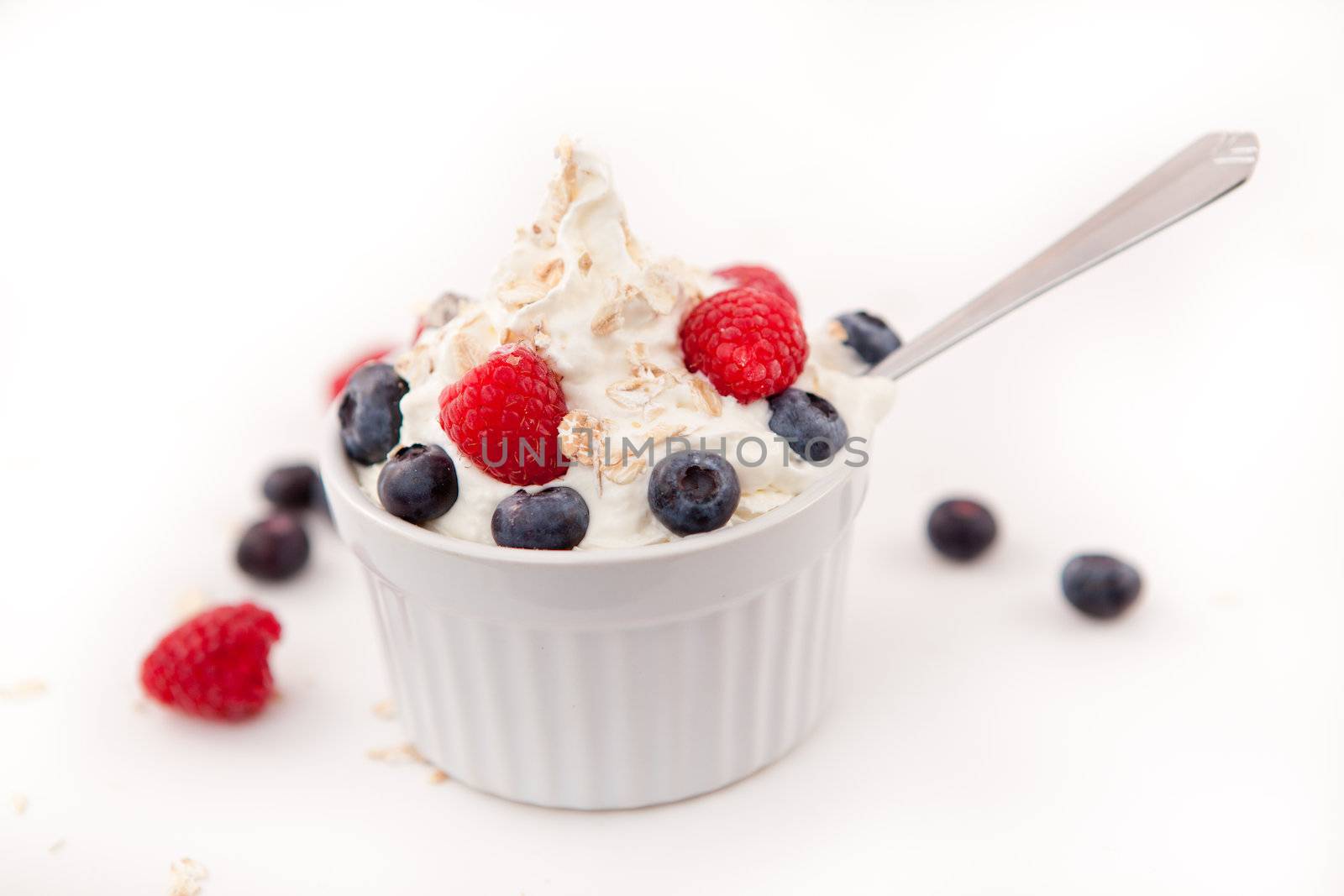 Jar of blueberries and raspberries in a whipped cream by Wavebreakmedia