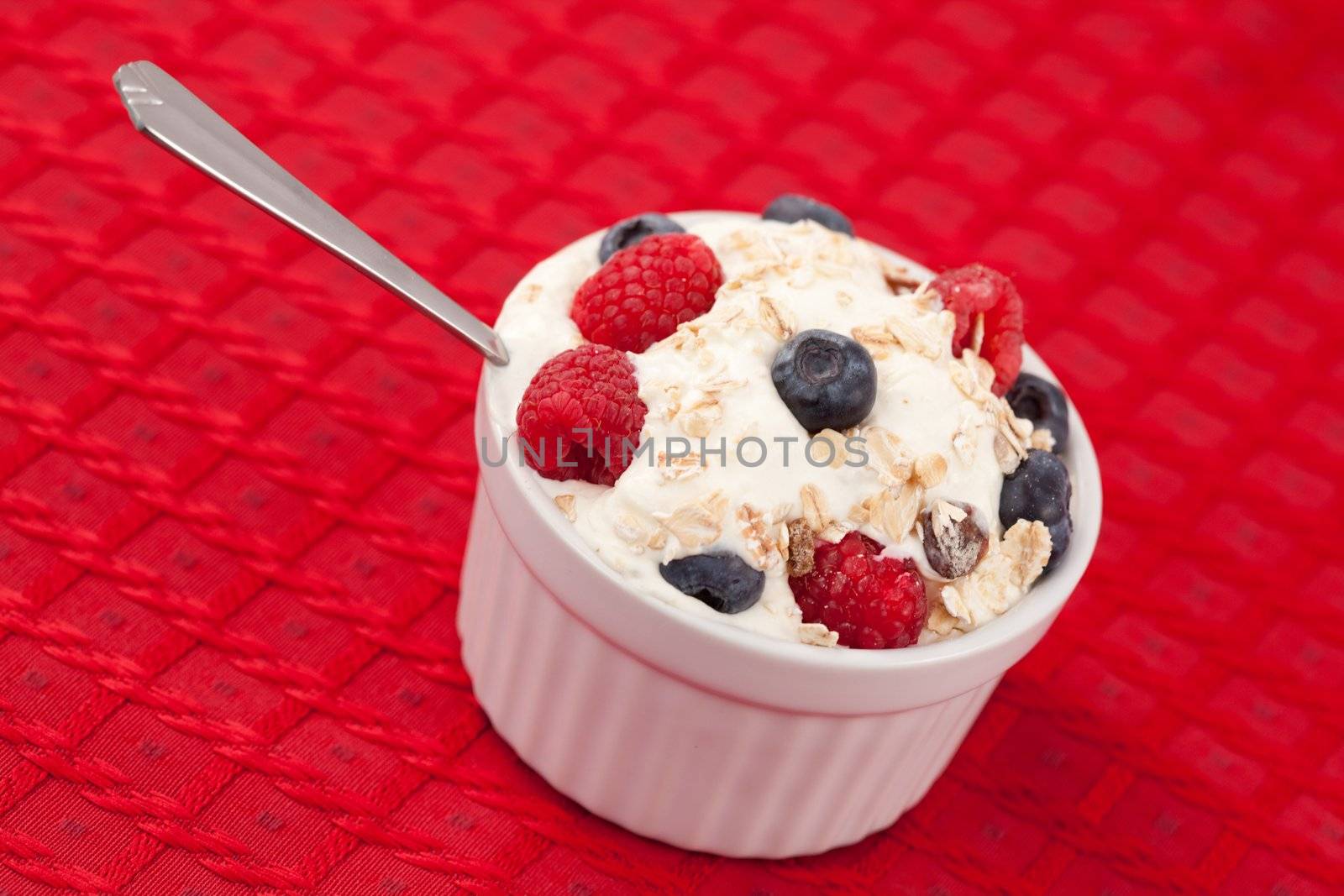 Pot of berries and whipped cream by Wavebreakmedia