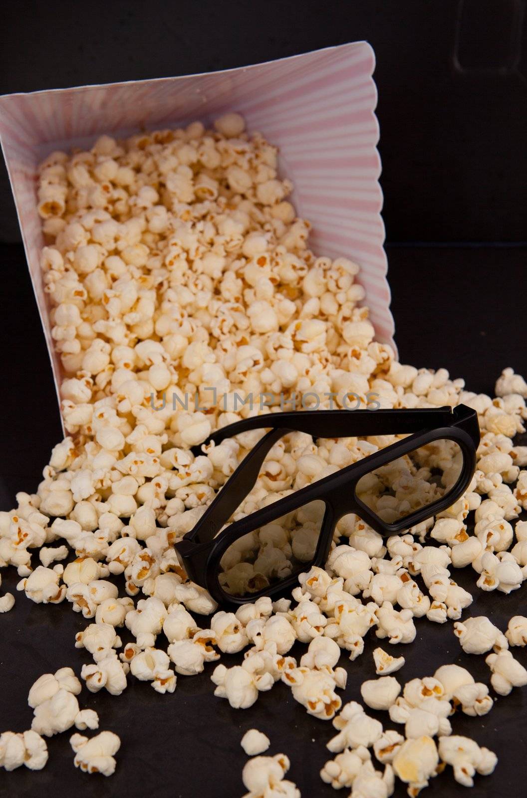 3D glasses on falling pop corn out of a box by Wavebreakmedia