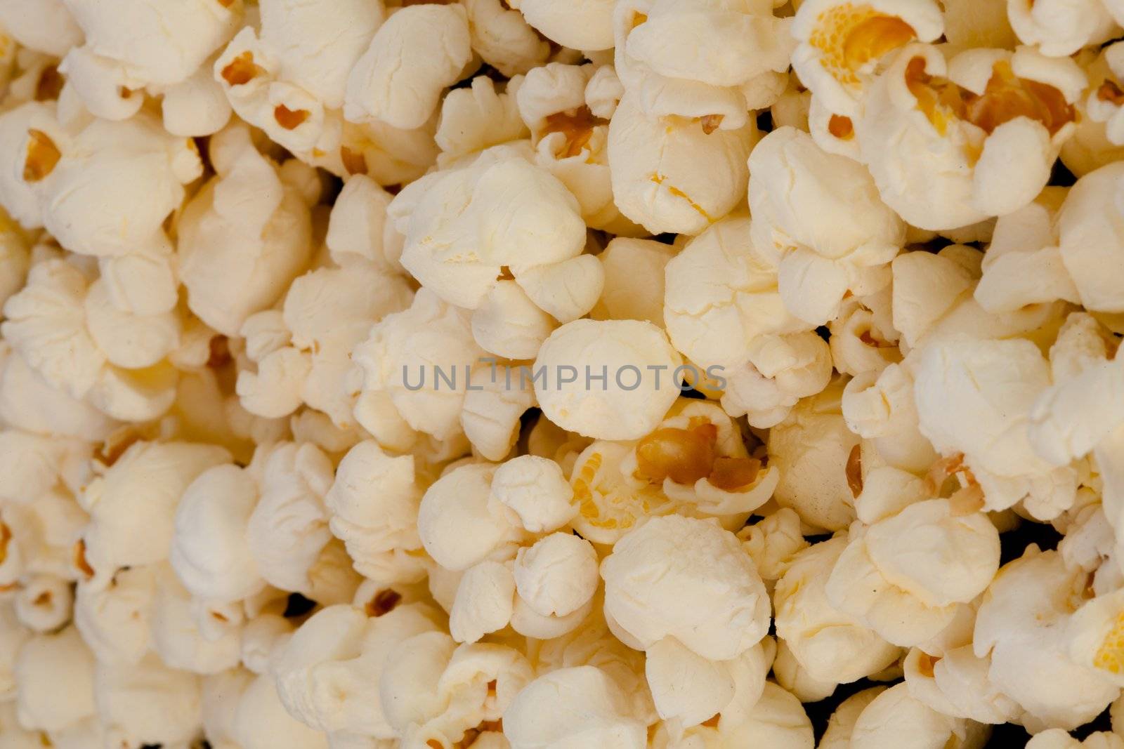 Horizontal close up on popcorn against a black background