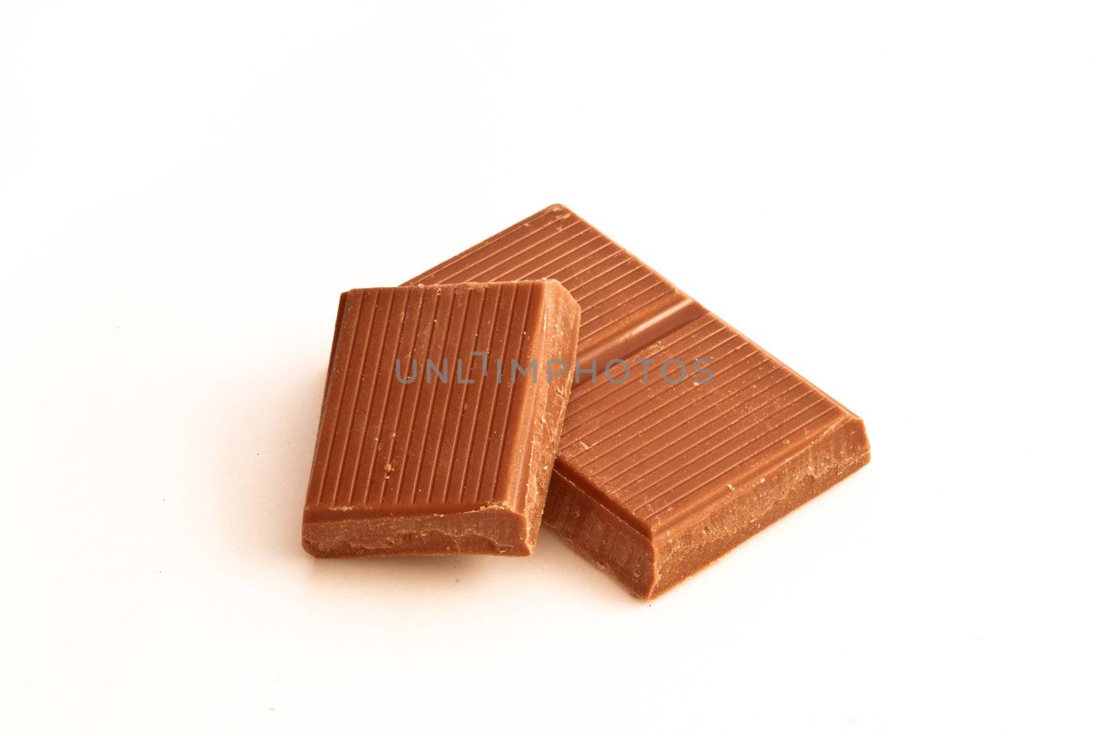 Dark chocolate pieces against a white background