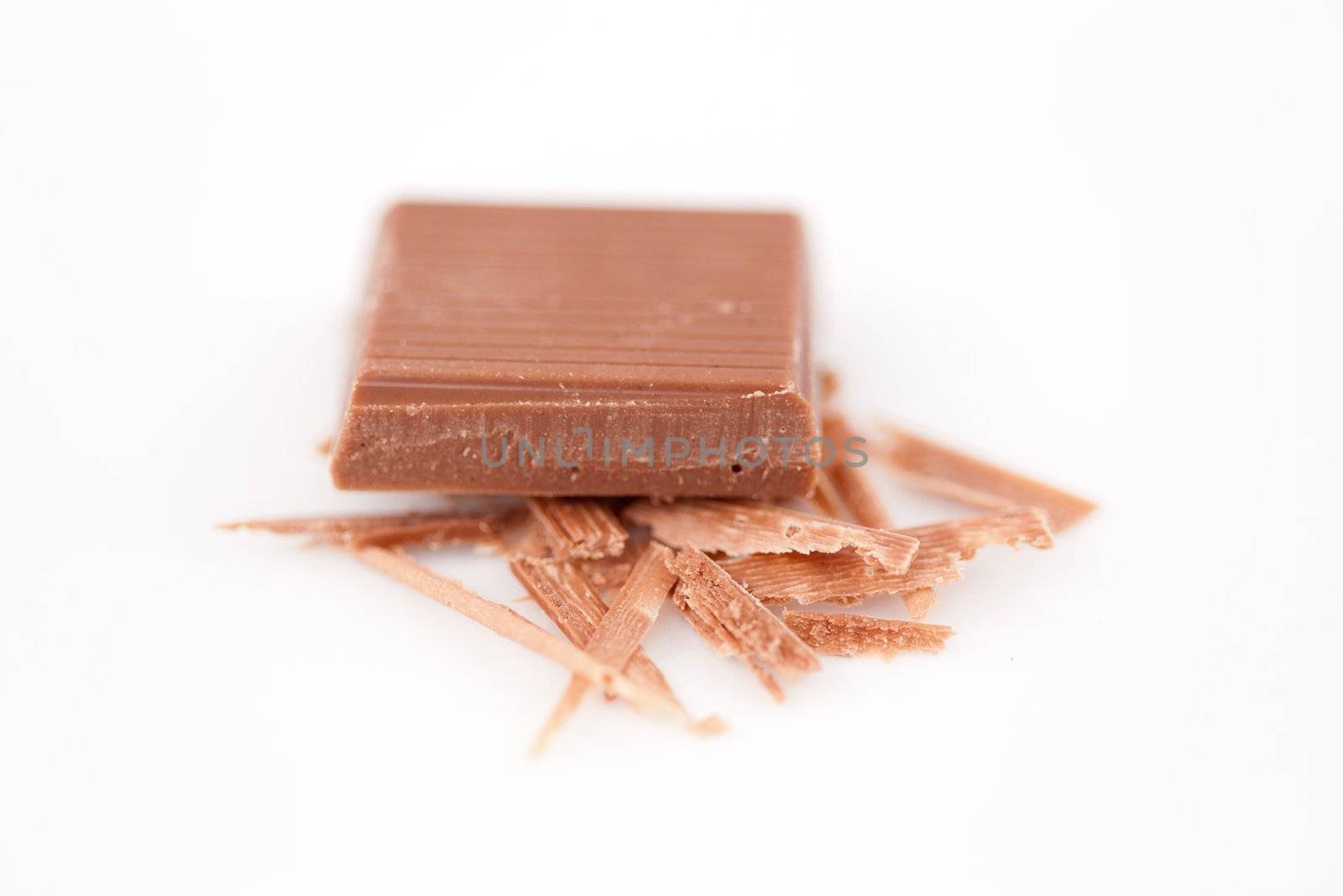 Close up of a piece of chocolate on chocolate shavings