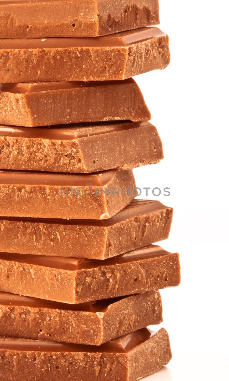 Close up of a pile of chocolate against a white background