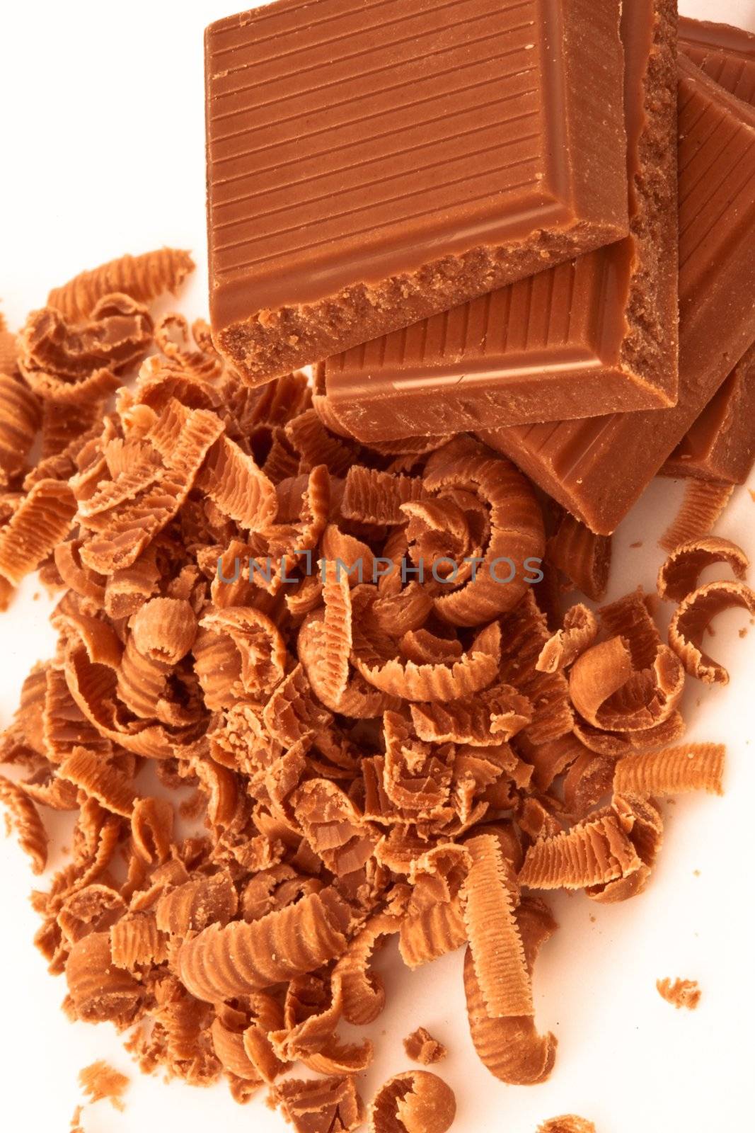 Close up of pile of chocolate pieces and chocolate shavings by Wavebreakmedia