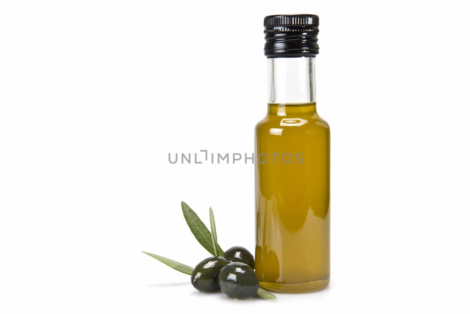 Glass bottle of premium virgin olive oil and some olives with leaves isolated on a white background