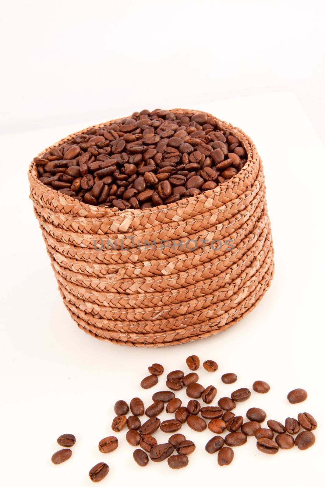 Close up of a basket full of coffee seeds with seeds lying in fr by Wavebreakmedia