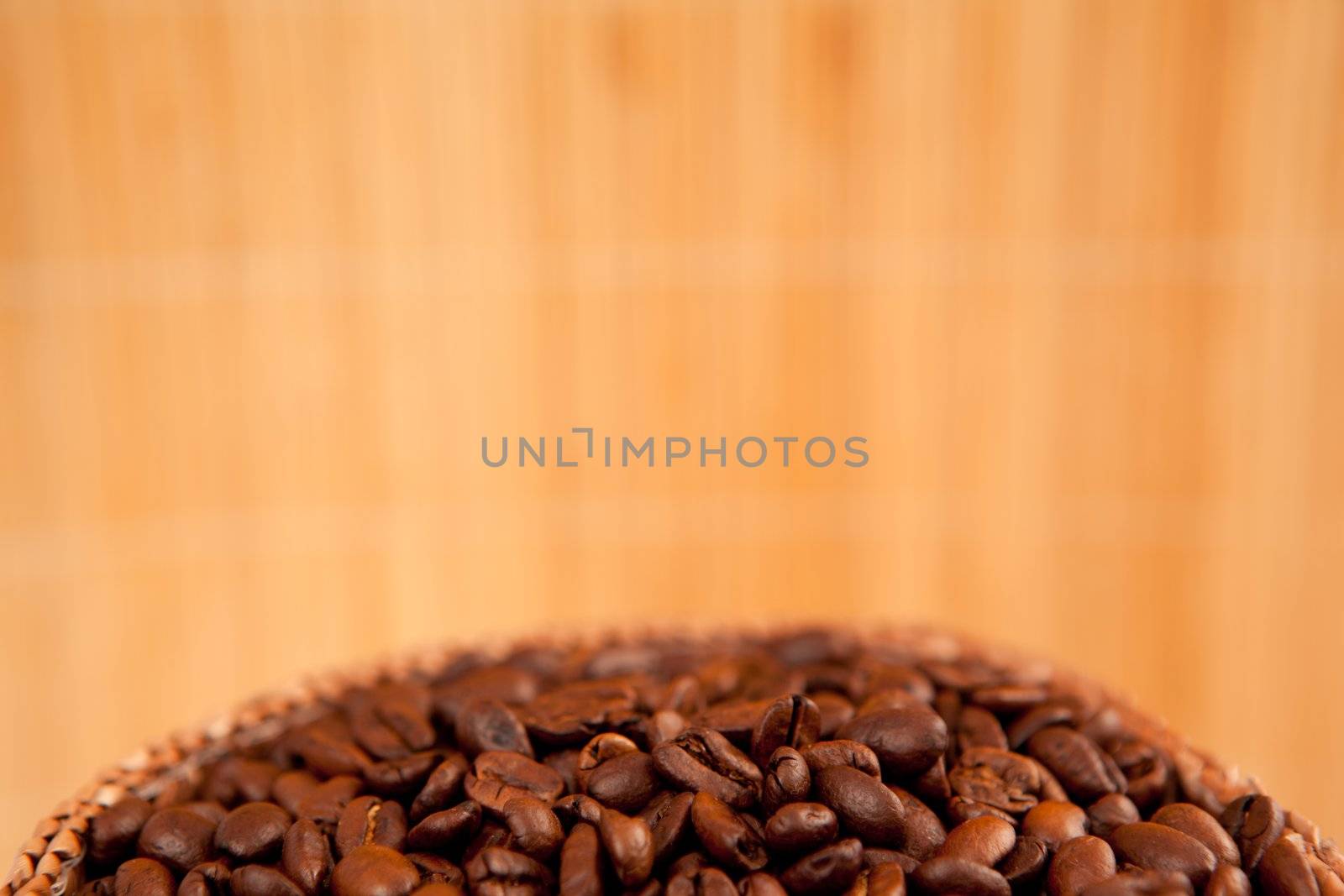 Close up of the top of a basket full of roasted coffee seeds