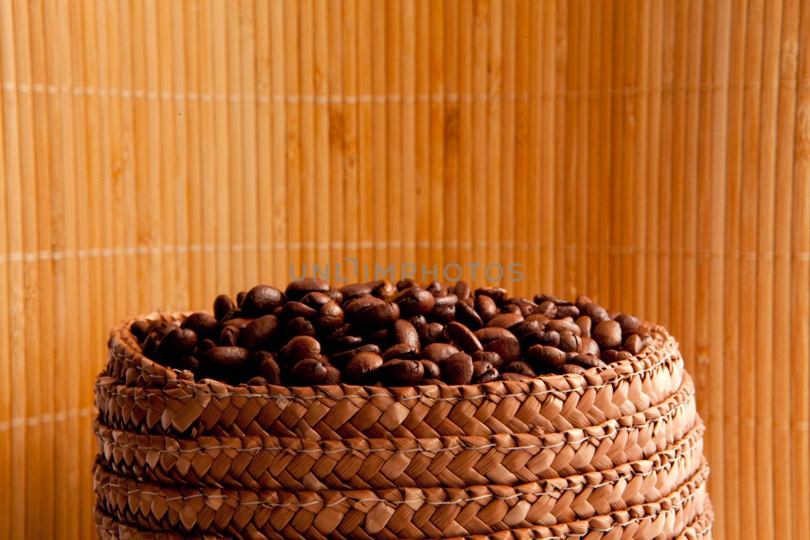 Top of a basket full of roasted coffee seeds by Wavebreakmedia