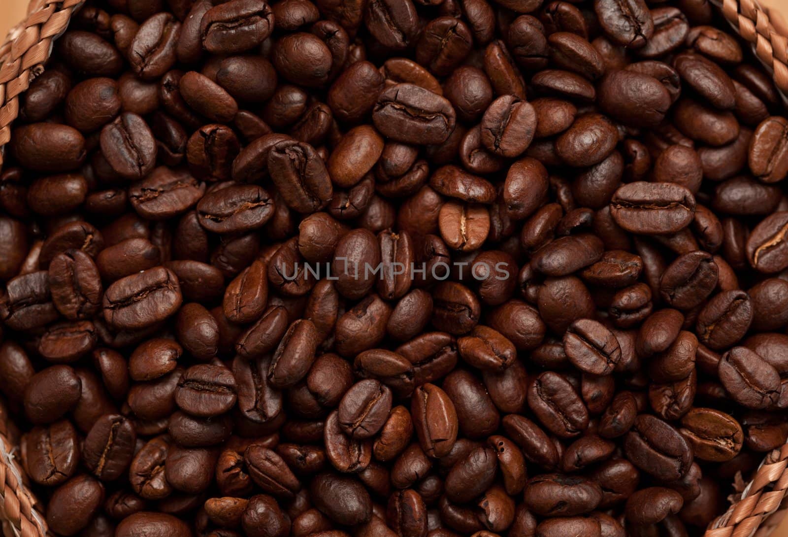 Extreme close up of a basket full of dark coffee beans