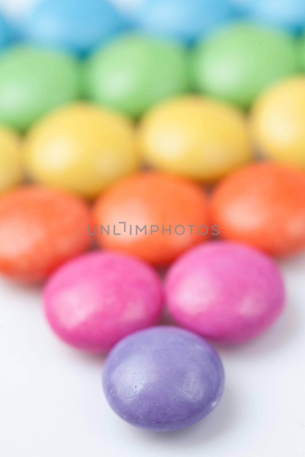 Abundance of candies multi coloured against a white background