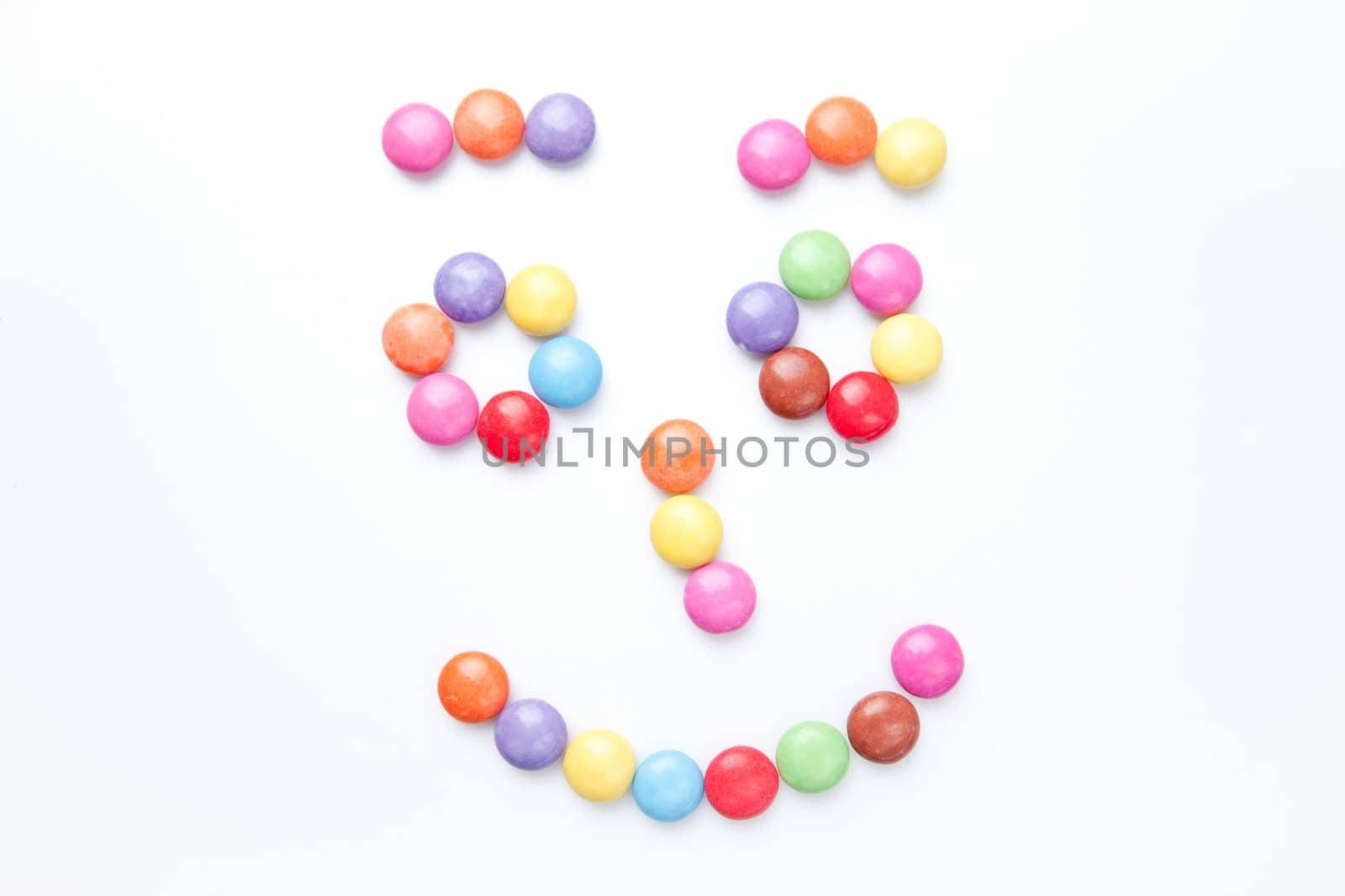 Face of candies against a white background