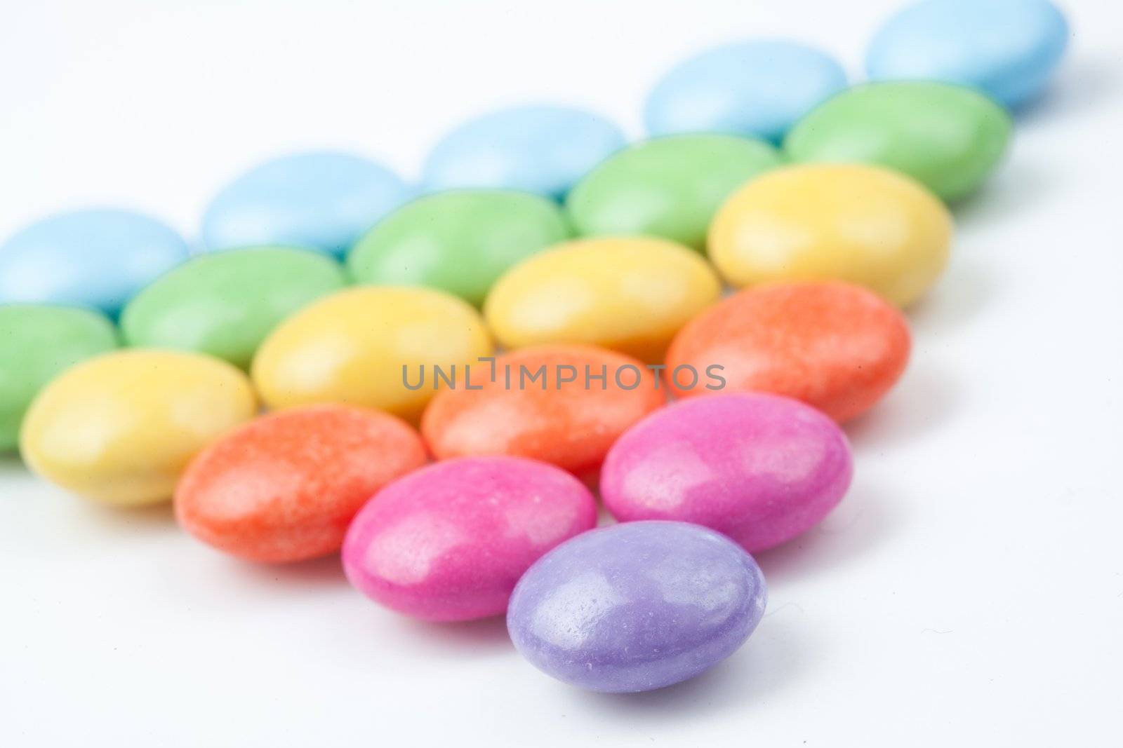 Triangle of candies against a white background