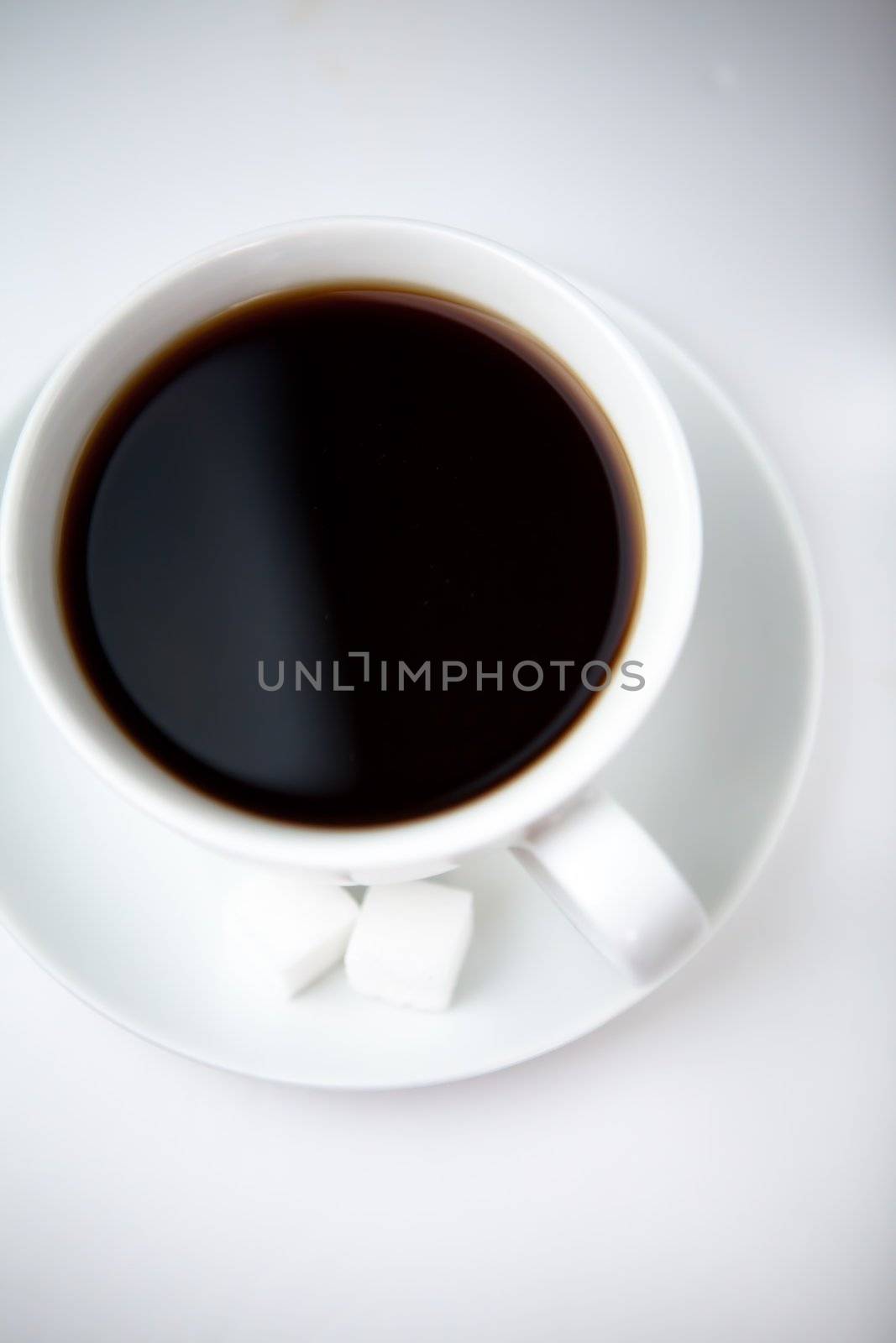 Cup of black coffee against a white background