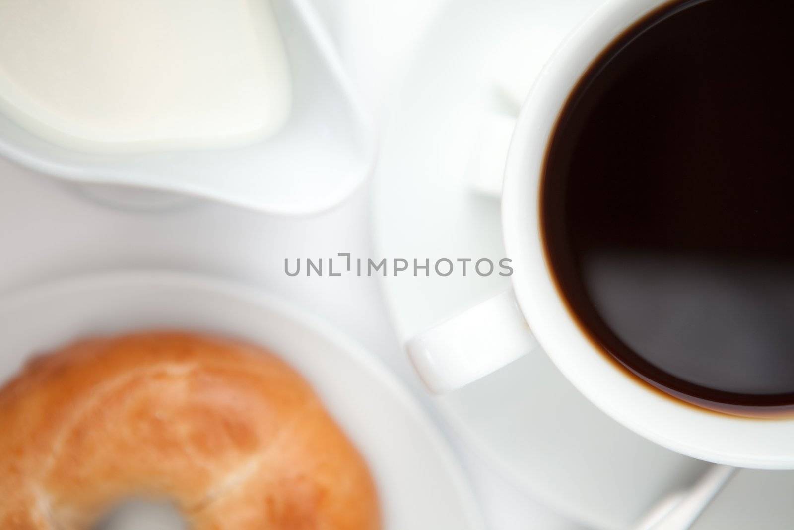 Black coffee  with donut against a white background