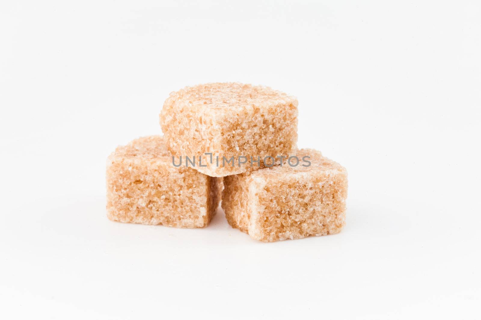 Brown sugars against a white background
