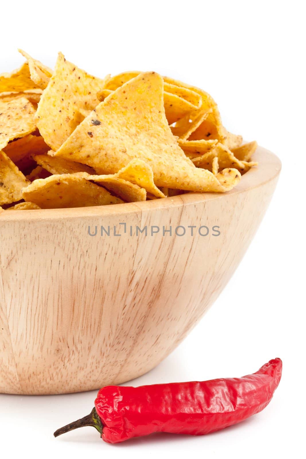Pimento near to a bowl of crisps against white background