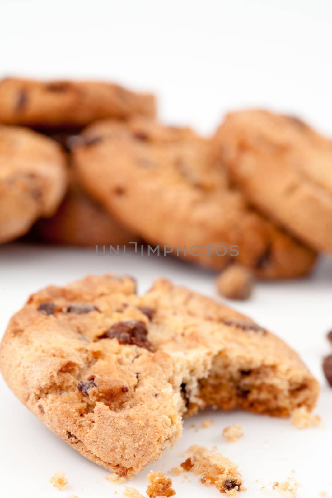 Tasted cookie in front of a stack of cookies  by Wavebreakmedia