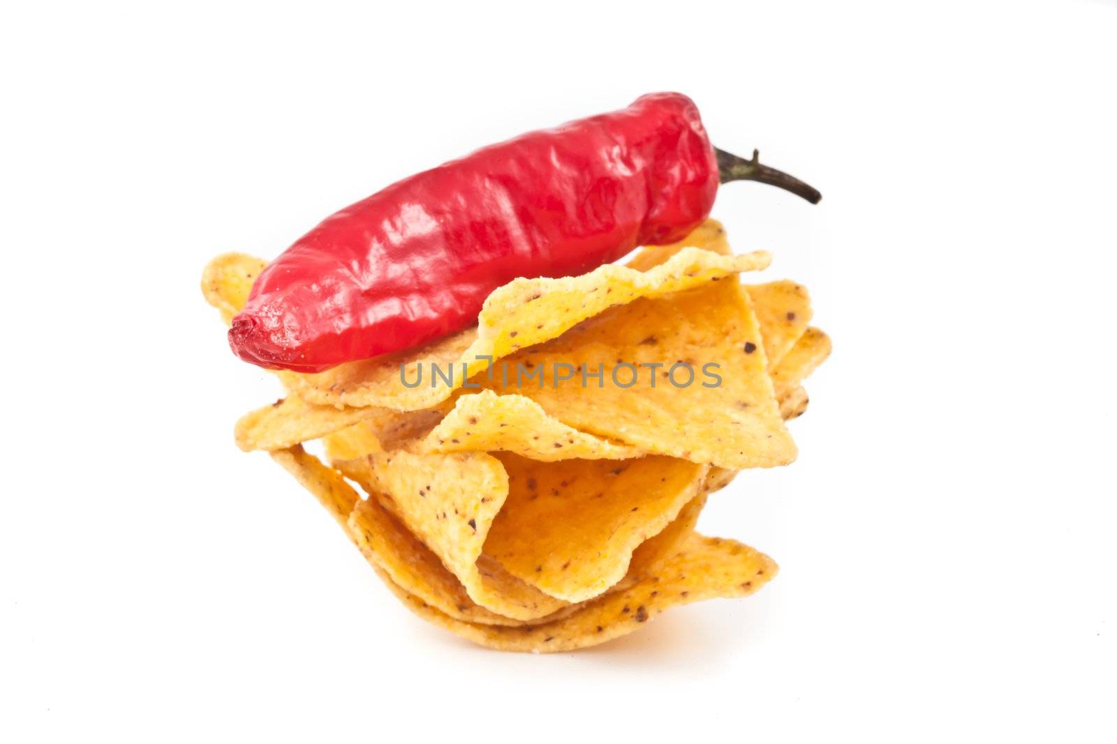 Pepper upon a small stack of crisps against white background