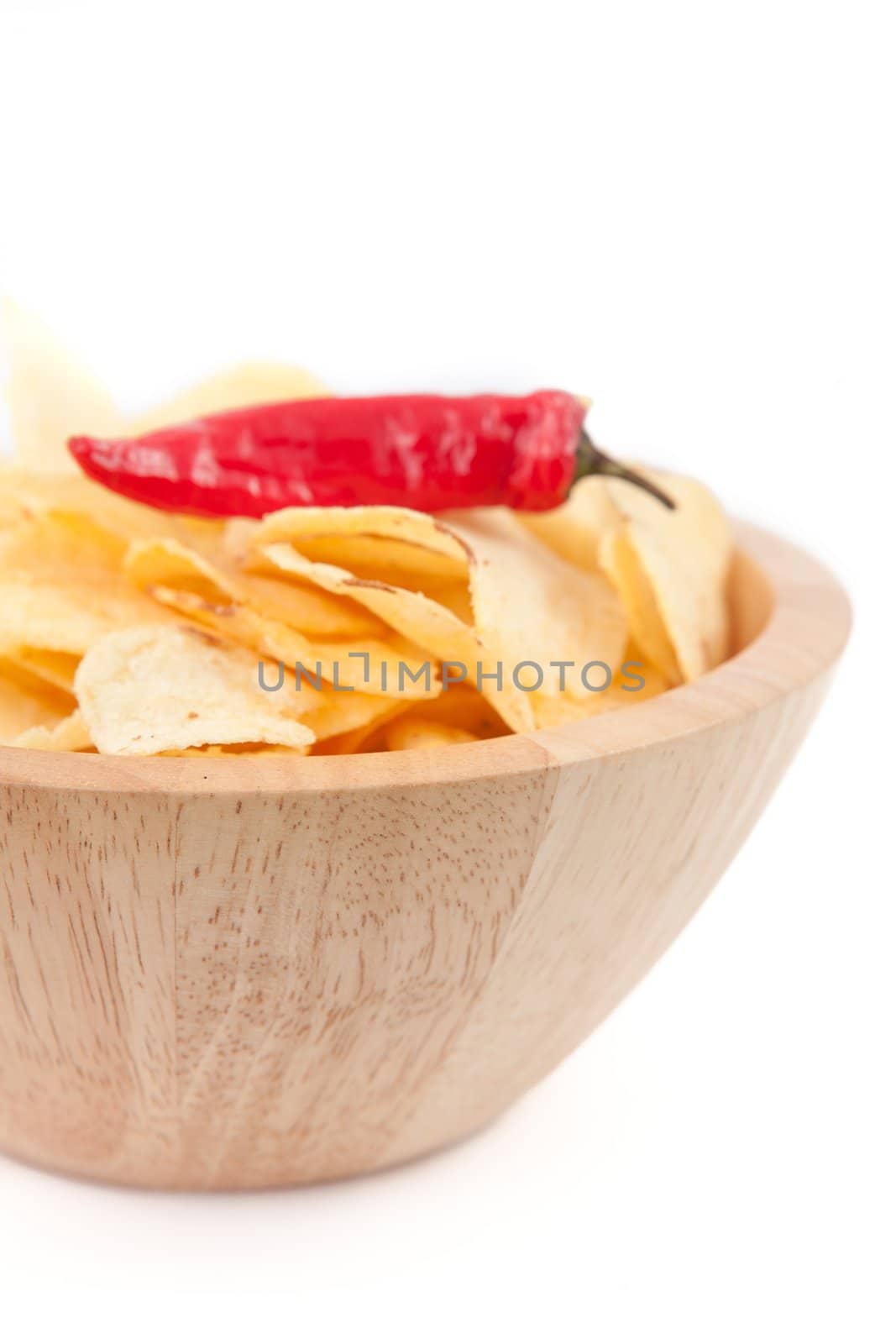 Pimento on a wooden bowl of chips against white background