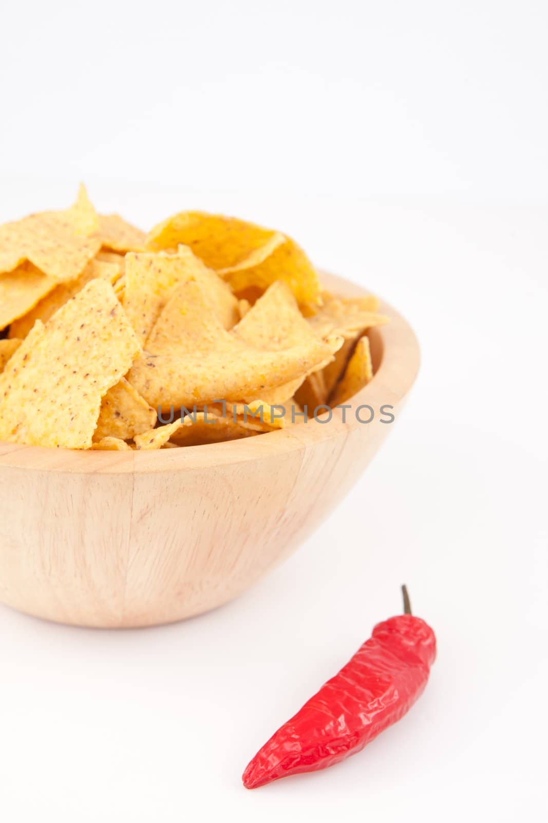 Pimento near a full bowl of crisps  against white background