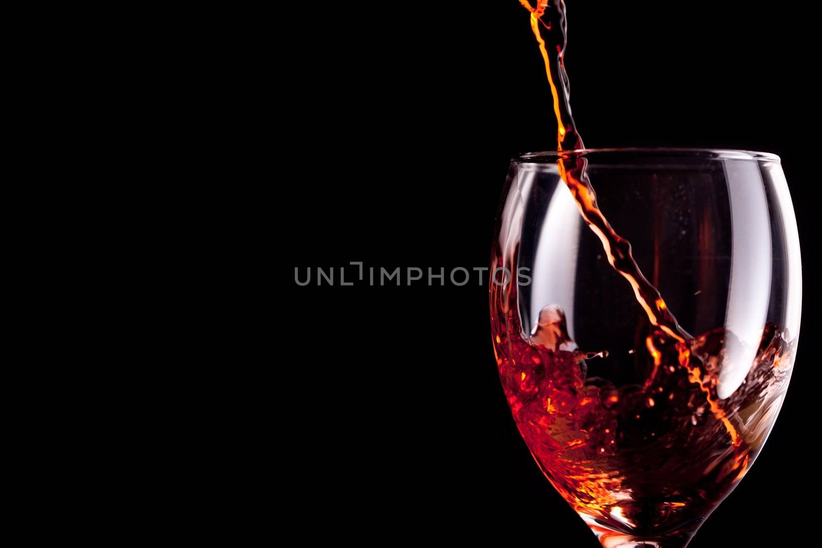 Empty stemware being filled with wine 