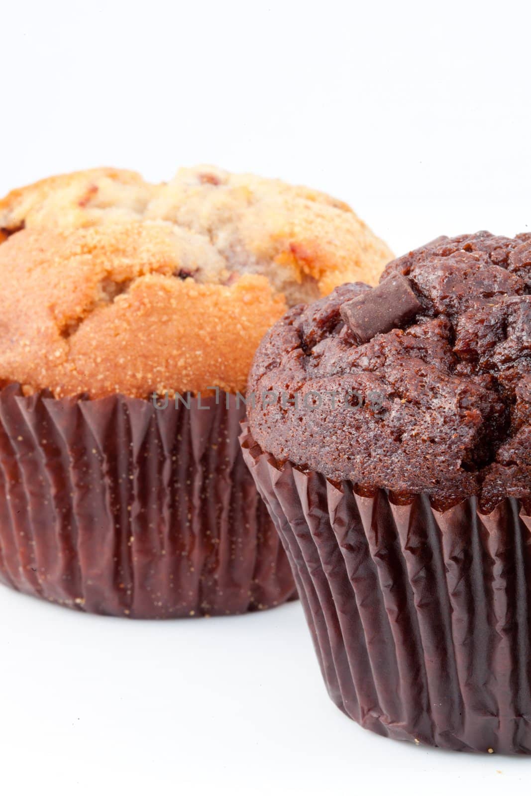 Close up of two muffins against a white background