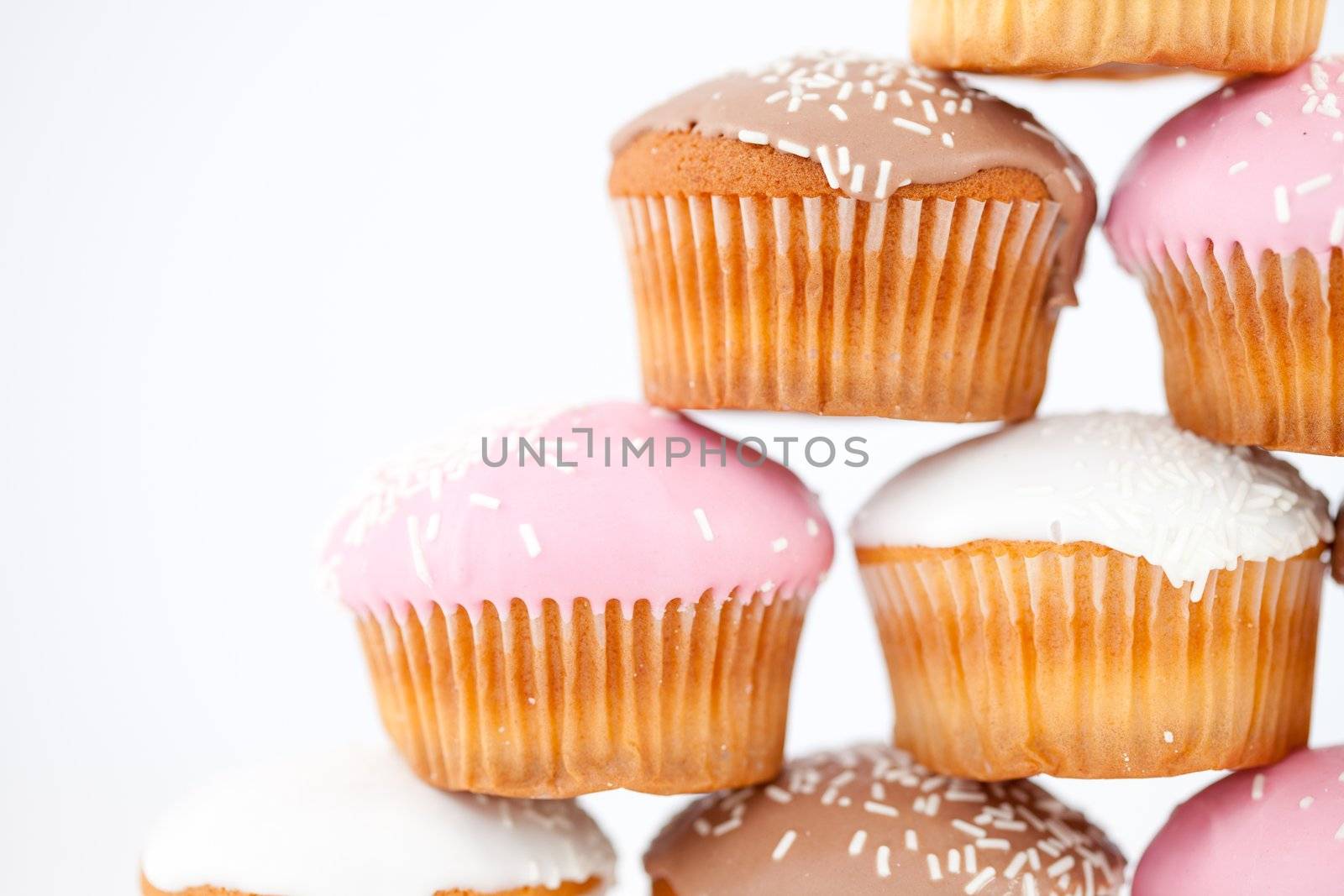 Close up on a pyramid of muffins against a white background