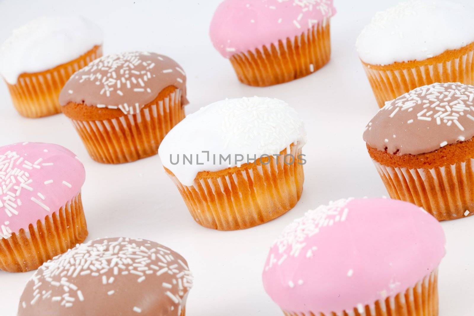Muffins with icing sugar against a white background