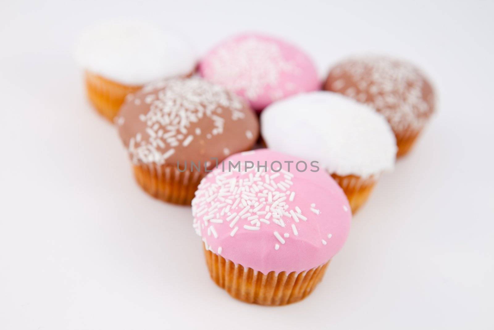 Blurred muffins placed in pyramid against a grey background