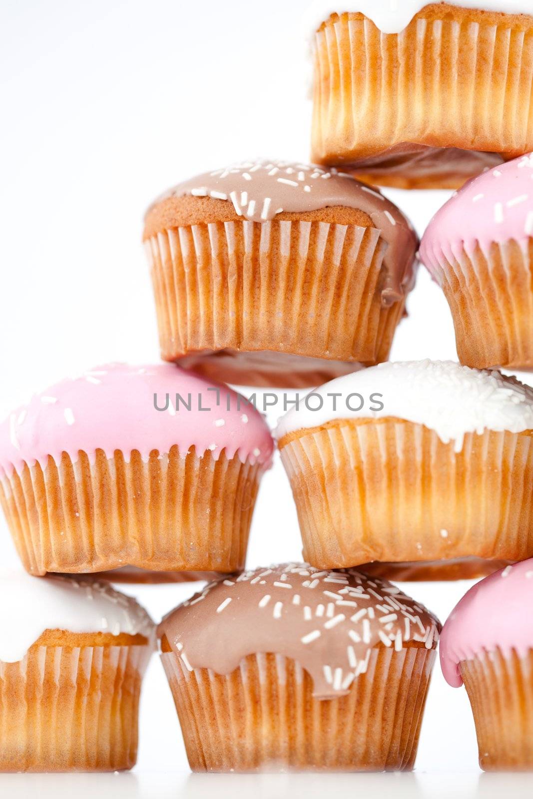 Close up on eight muffins with icing sugar placed in pyramid by Wavebreakmedia